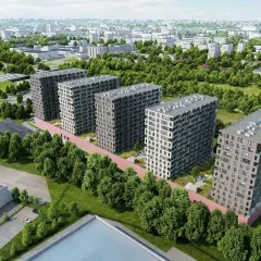 Nowoczesne bloki mieszkalne otoczone zielenią, z widokiem na miasto pod **tuwima sky**.