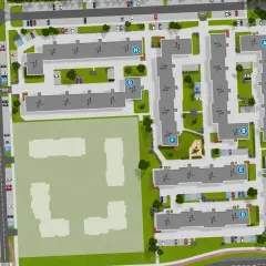 Widok z lotu ptaka na osiedle mieszkaniowe "Zielony Zakątek Toruń" z budynkami, parkingami, placem zabaw i terenami zielonymi.