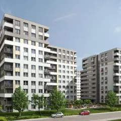 Nowoczesne budynki mieszkalne na osiedlu Avia Kraków, z zielenią i placem zabaw.