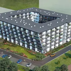Nowoczesny budynek mieszkalny Chodźki Residence z licznymi balkonami i zielenią wokół.