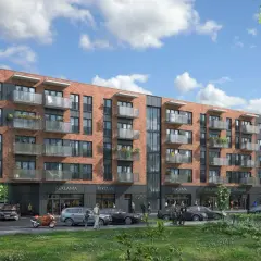 Nowoczesny budynek mieszkalny z balkonami i lokalami usługowymi na parterze. Na szyldzie widnieje napis "Nyska Wrocław".