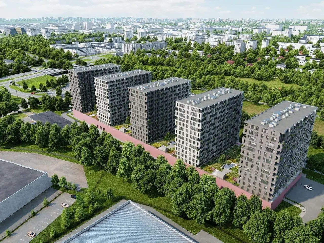 Nowoczesne bloki mieszkalne otoczone zielenią, z widokiem na miasto pod **tuwima sky**.
