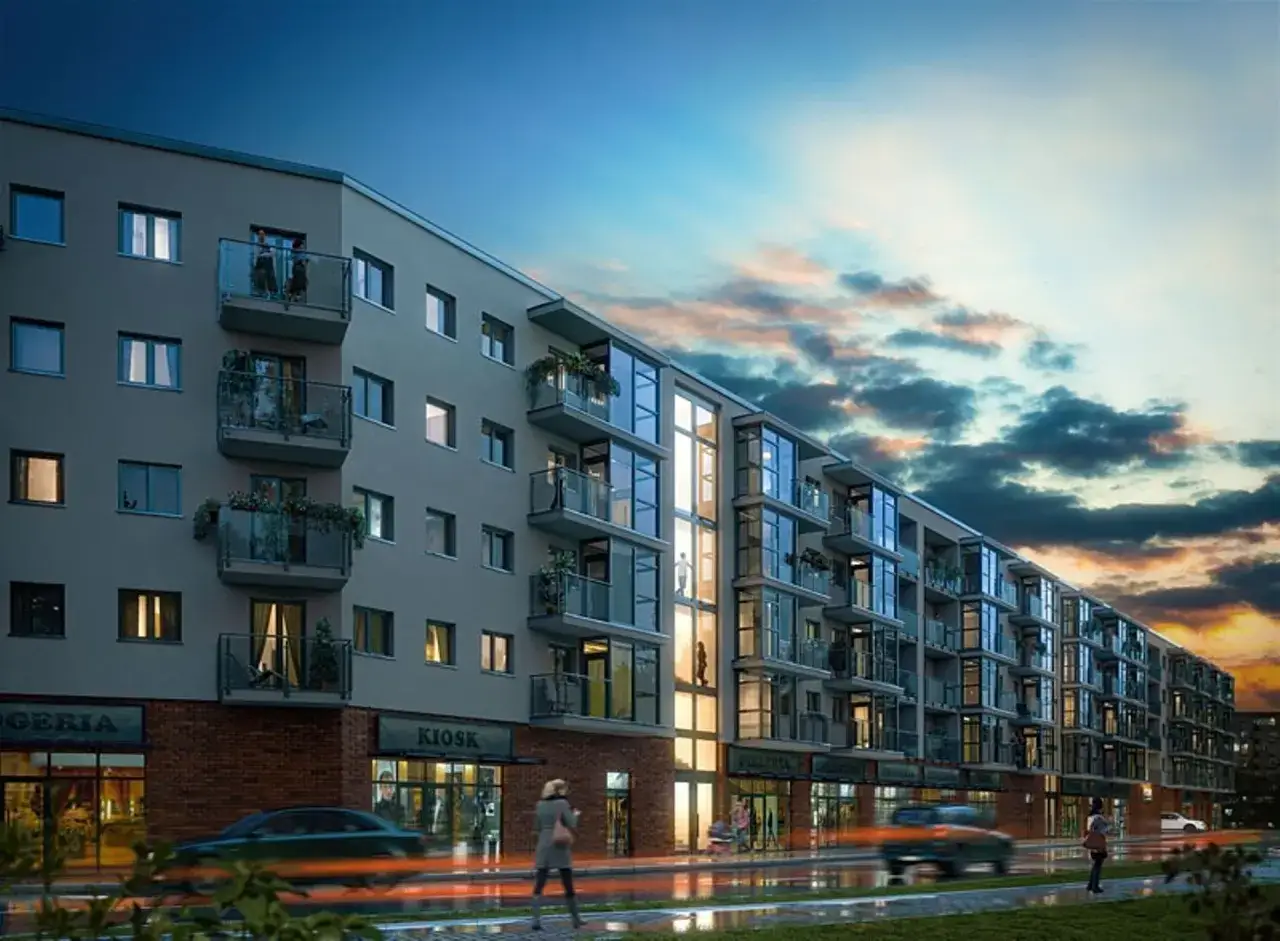 Nowoczesny budynek mieszkalny Nyska Residence z balkonami i przeszklonymi fasadami, oświetlony o zmierzchu.